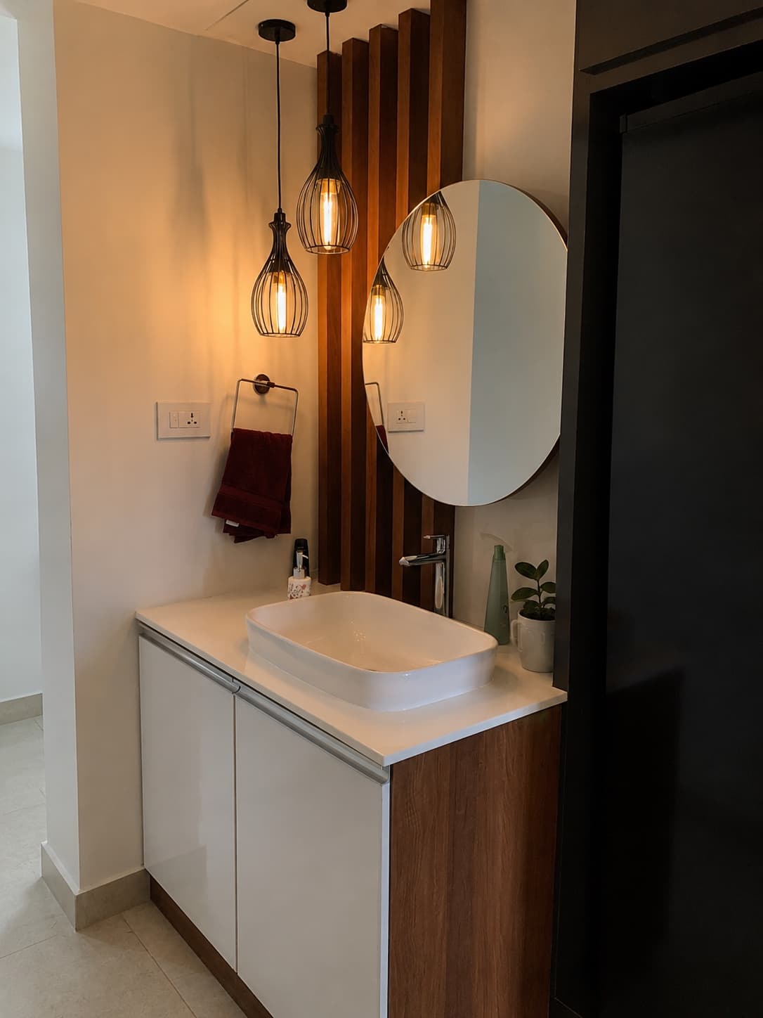 Finished joinery — timber battens and a round mirror